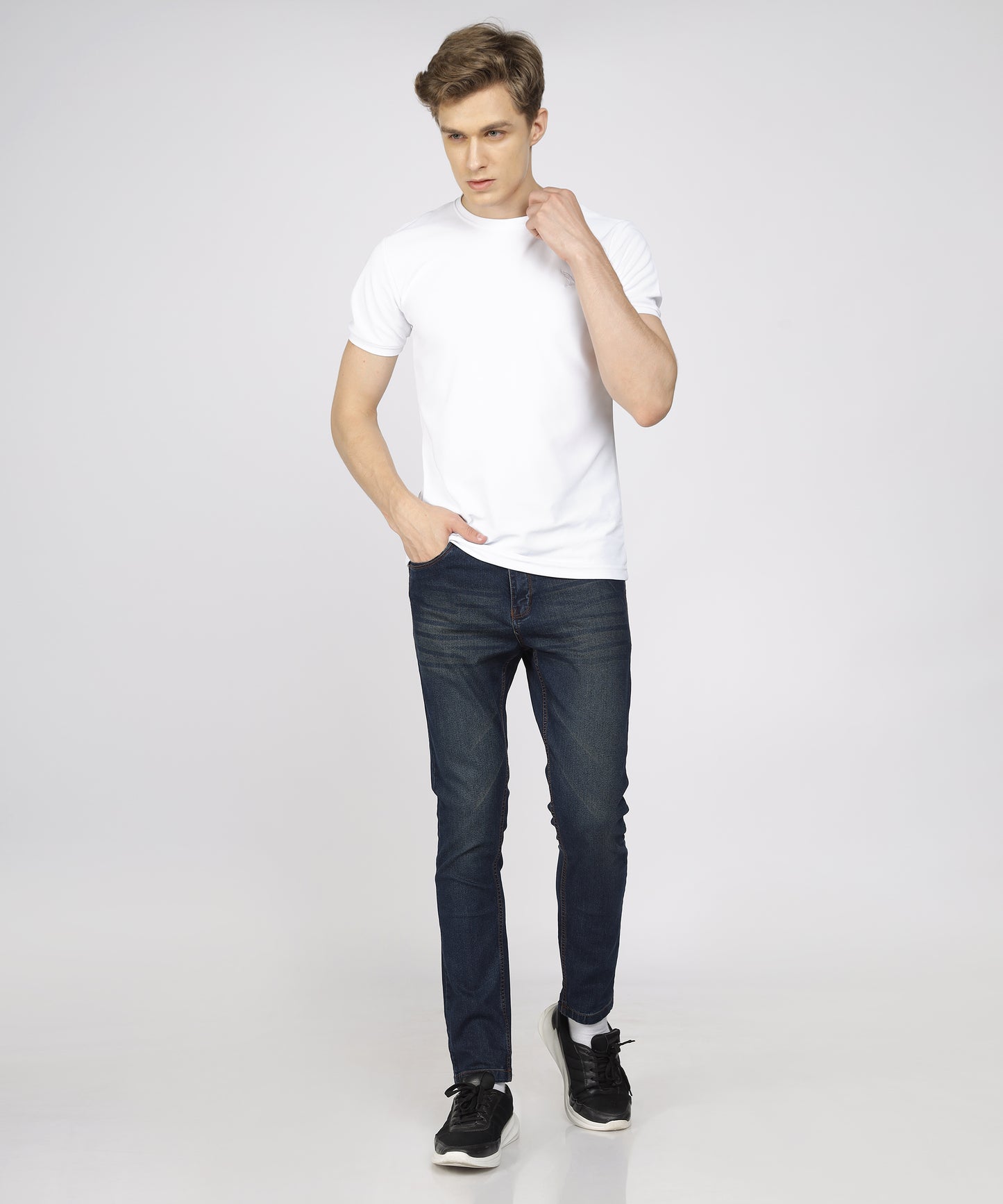 Model showcasing TCI Men’s Corbon Blue Jeans styled for casual wear.