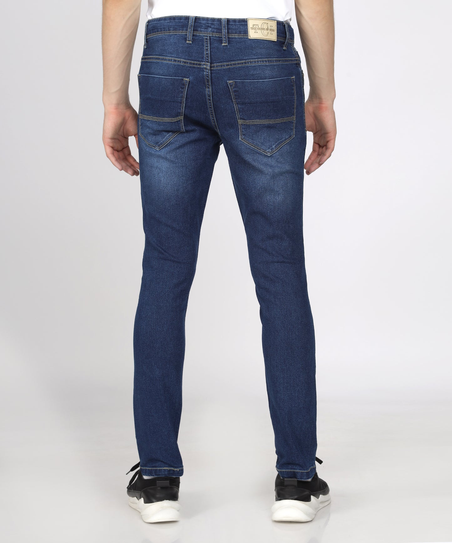 Back view of TCI Men’s Mid Blue Slim Fit Stretchable Jeans on display.